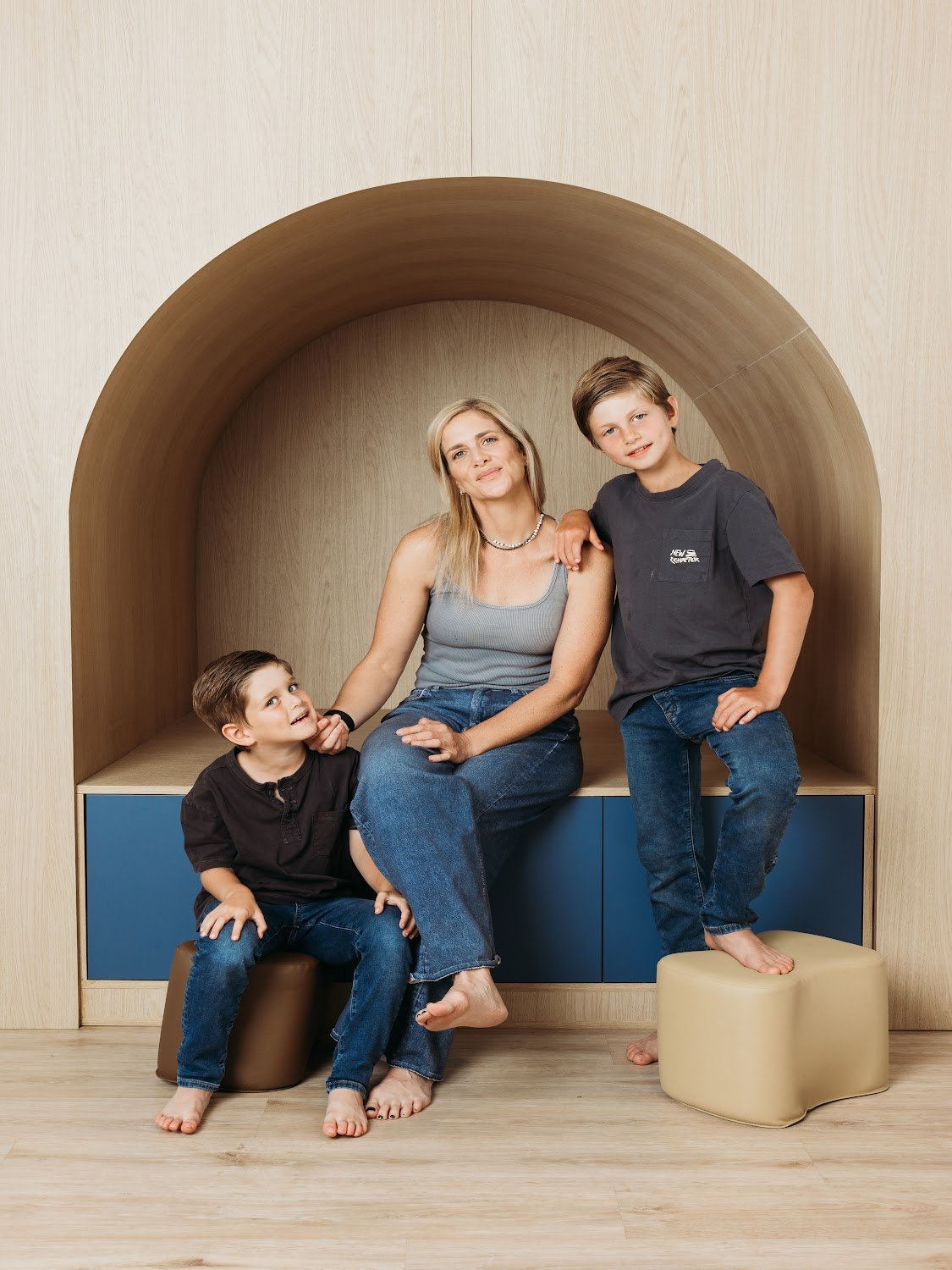 Natalie with her kids in the reading nook at Rise Village